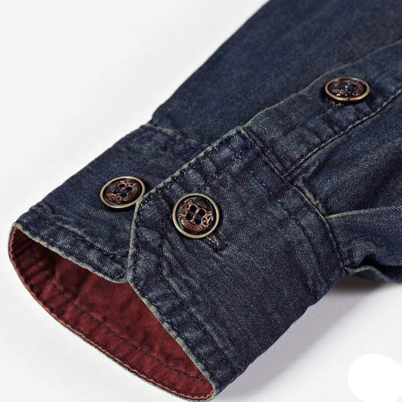 Dark denim shirt sleeve with brown buttons and red lining.