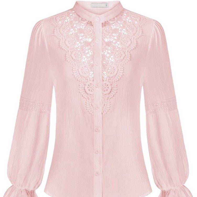 A pink, long-sleeved blouse with lace details.