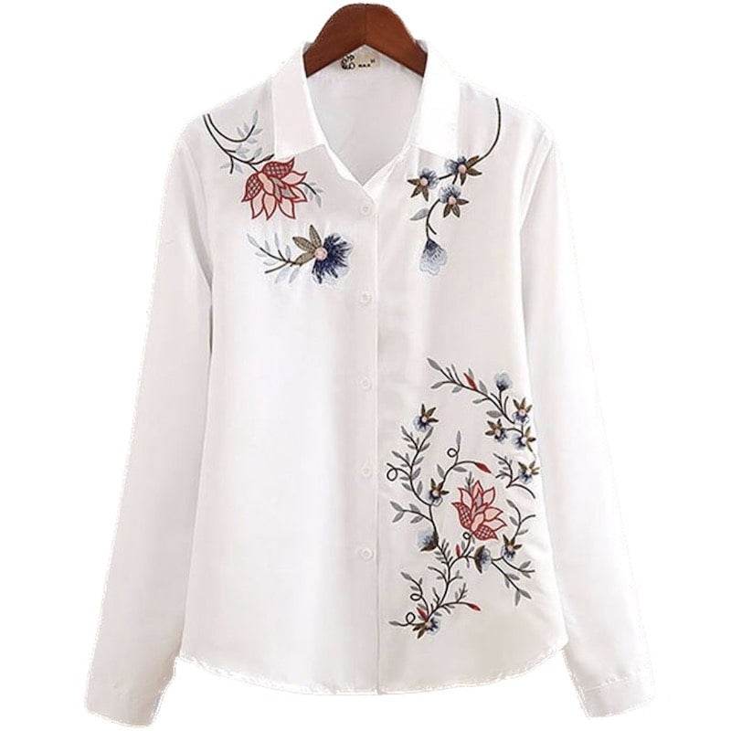 White long-sleeve shirt with floral embroidery.
