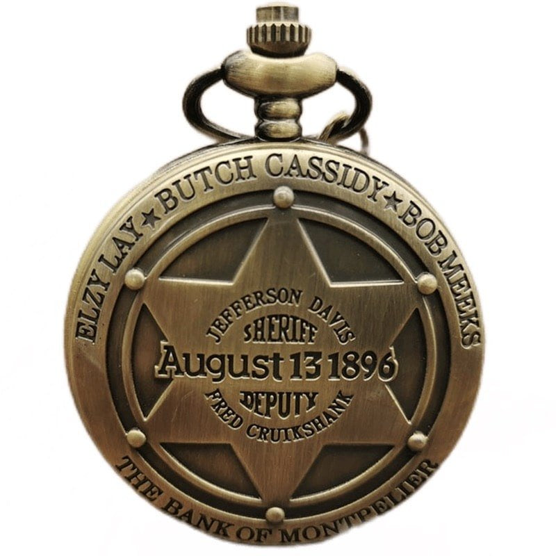 Close-up of a gold pocket watch with a sheriff badge emblem.