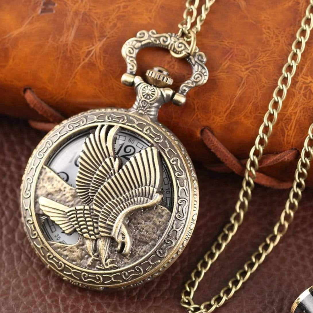 Bronze eagle pocket watch with gold chain.