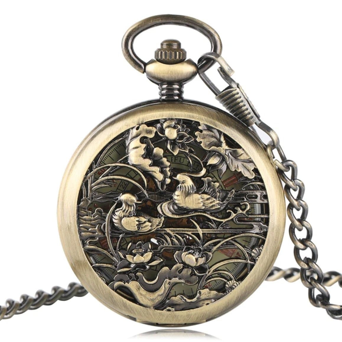 Close-up of an ornate bronze pocket watch with a scene of ducks and lotus flowers. 
