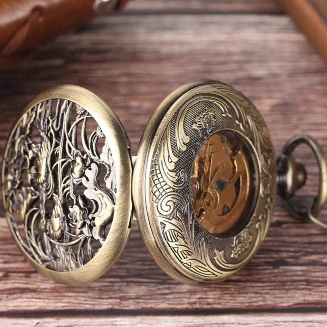Ornate bronze-colored pocket watch with open cover.
