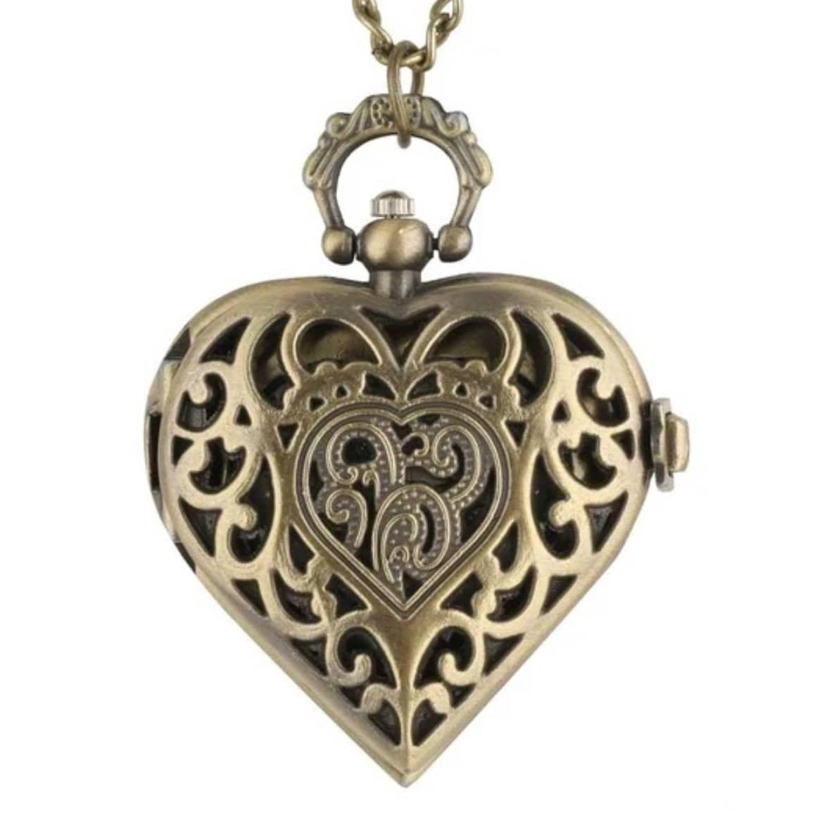 Close-up of an ornate, heart-shaped, antique bronze-colored pendant locket on a necklace. 
