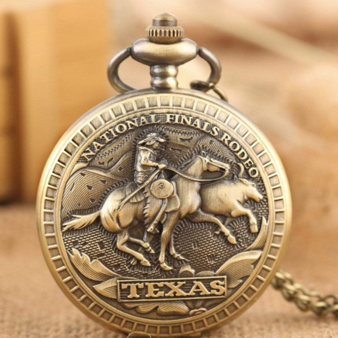 Gold pocket watch with cowboy on horseback, "National Finals Rodeo", and "Texas" text.
