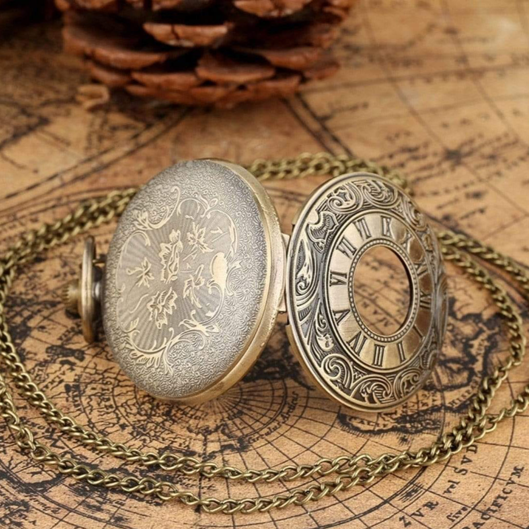 Open bronze pocket watch with chain, botanical designs, on map.