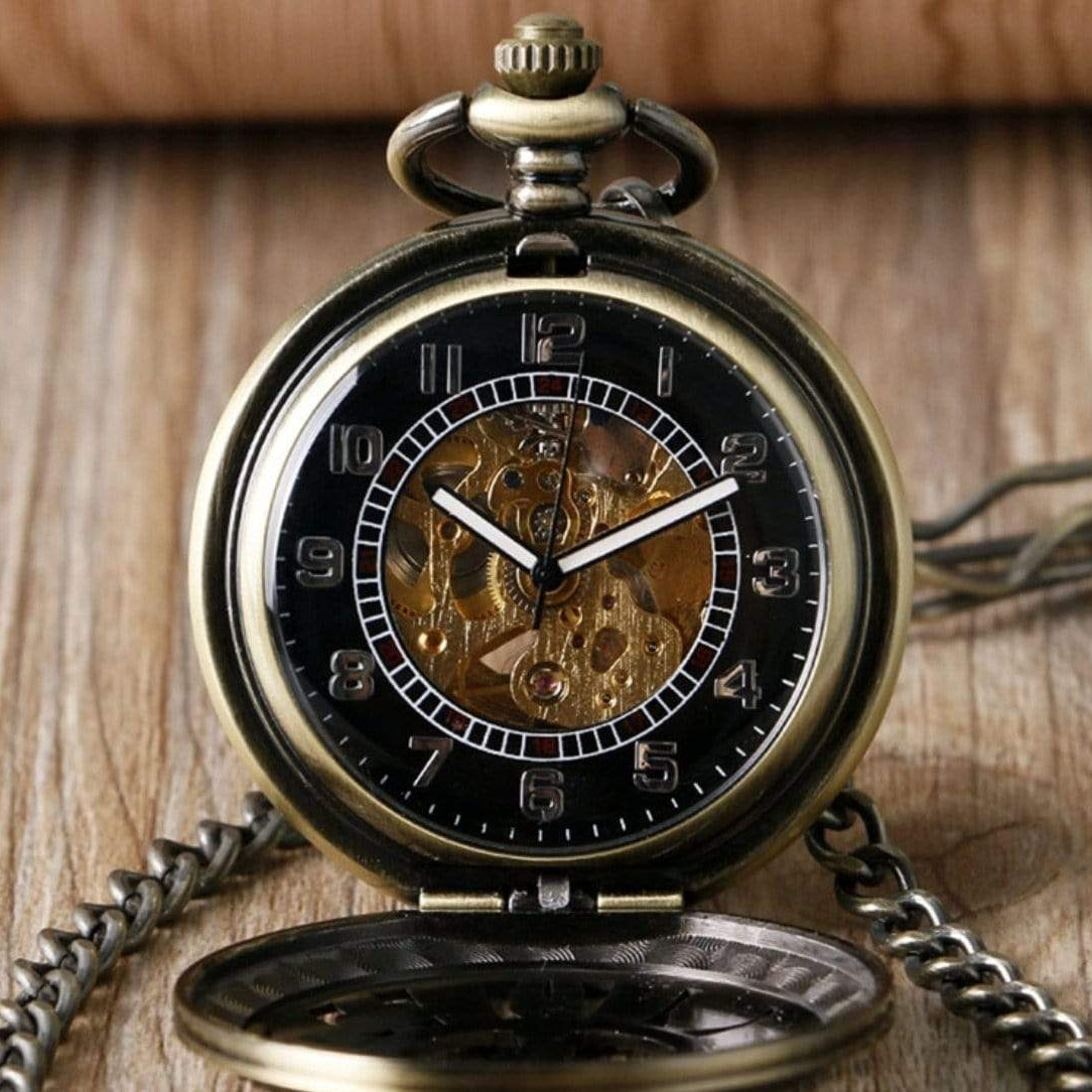 Antique brass pocket watch with visible gears and chain.
