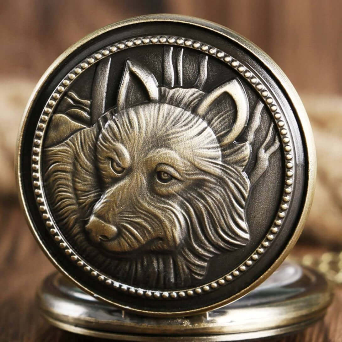 Bronze pocket watch with raised wolf design.