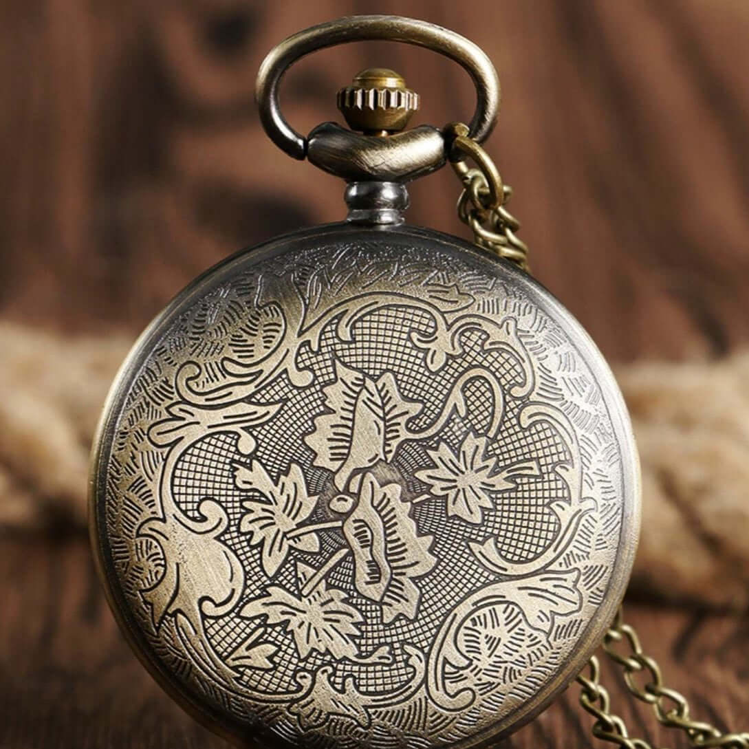 Close-up of an ornate bronze pocket watch.
