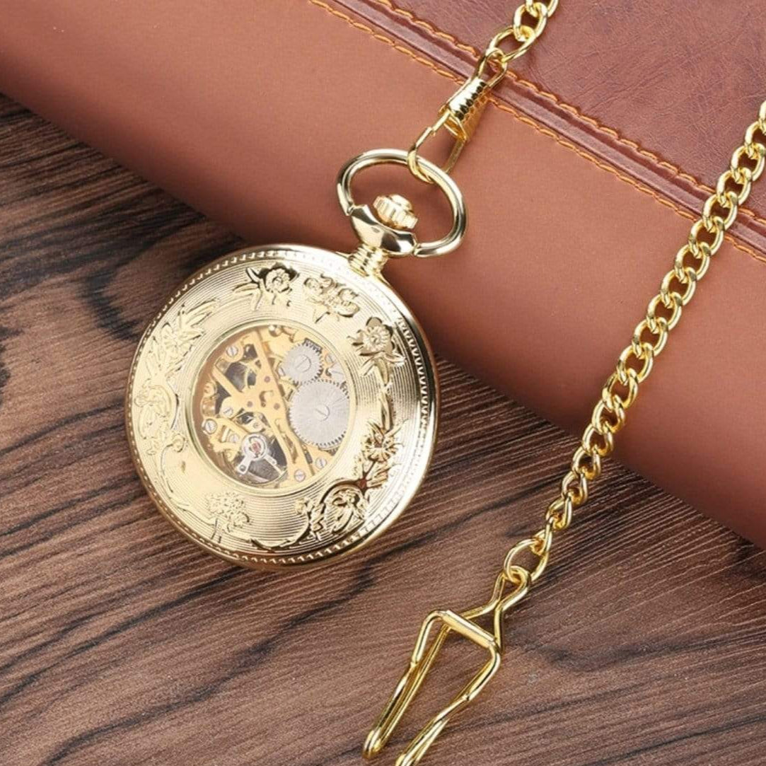 Gold skeleton pocket watch with chain.
