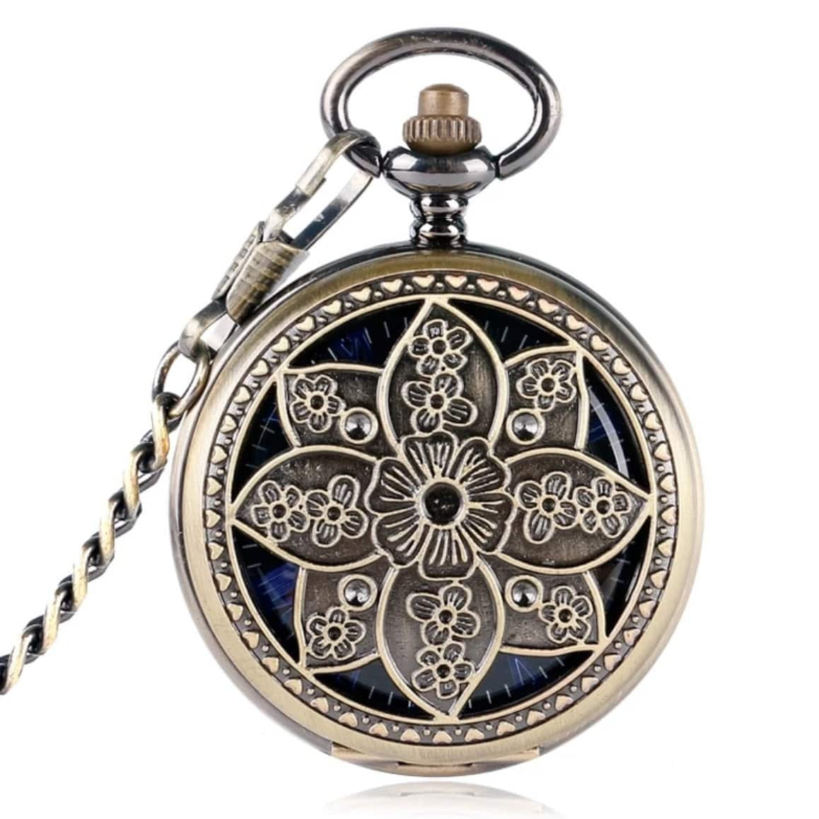 A close-up shot of a decorative antique pocket watch with a flower motif.