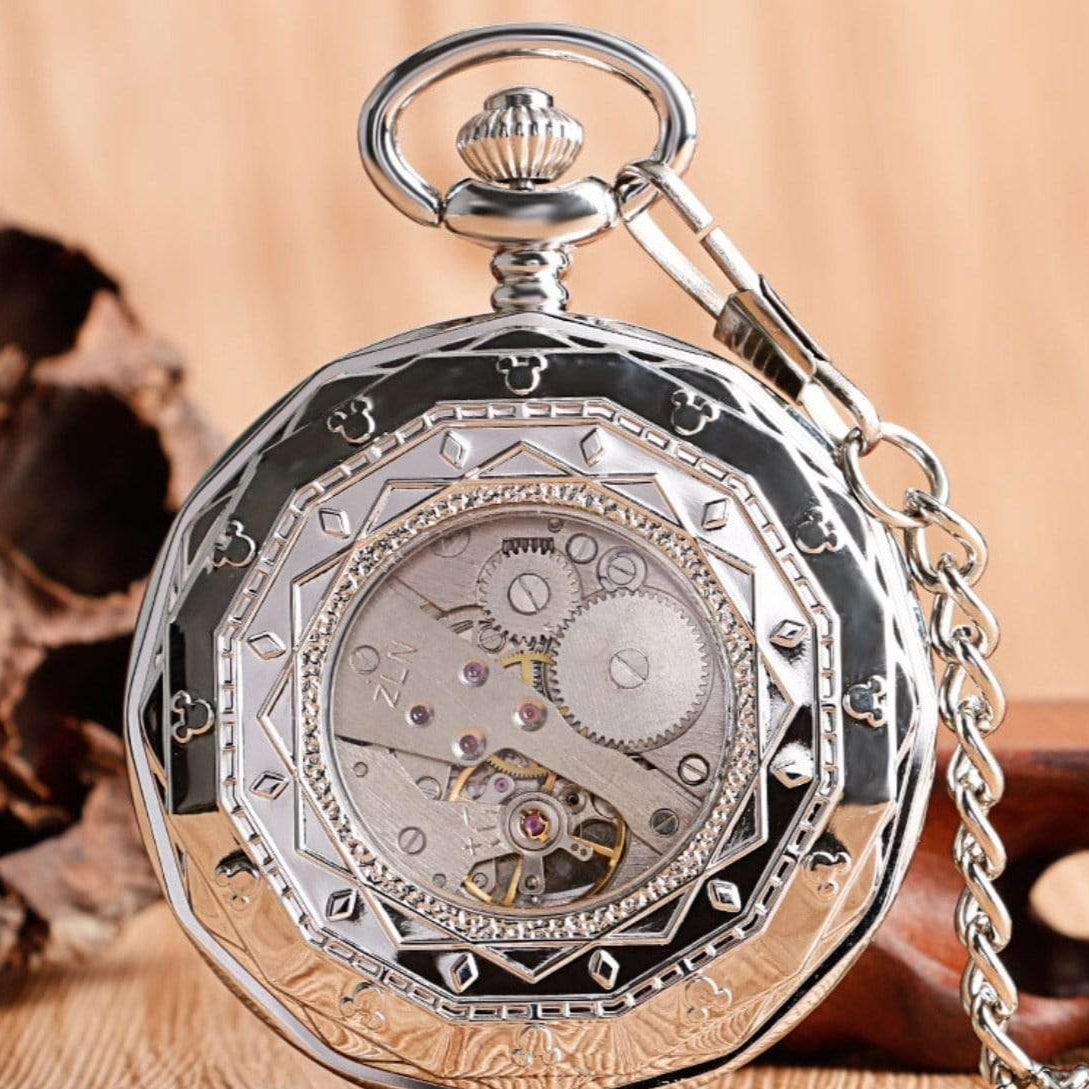 Silver pocket watch with visible gears.
