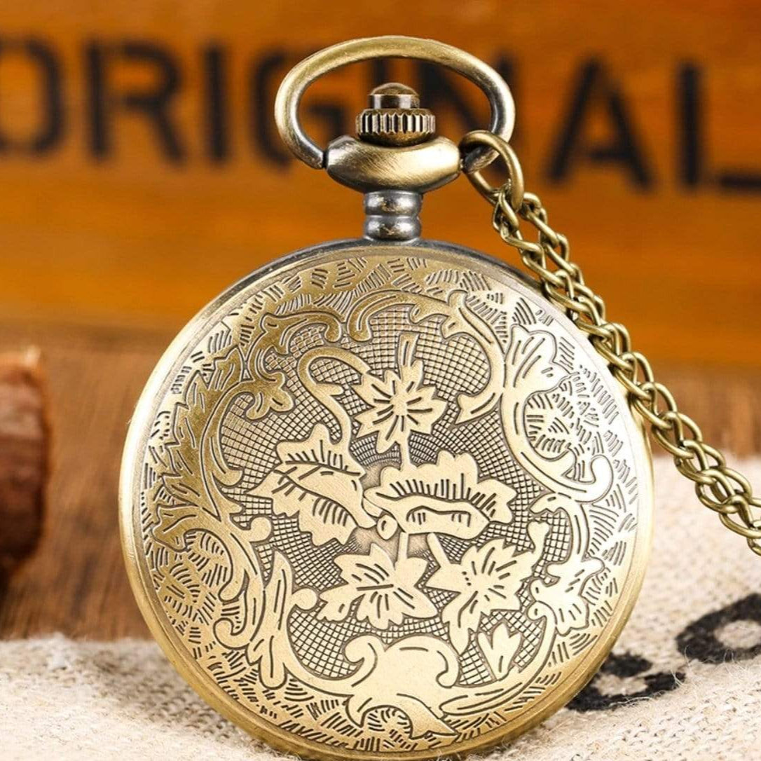 Gold pocket watch with floral design.
