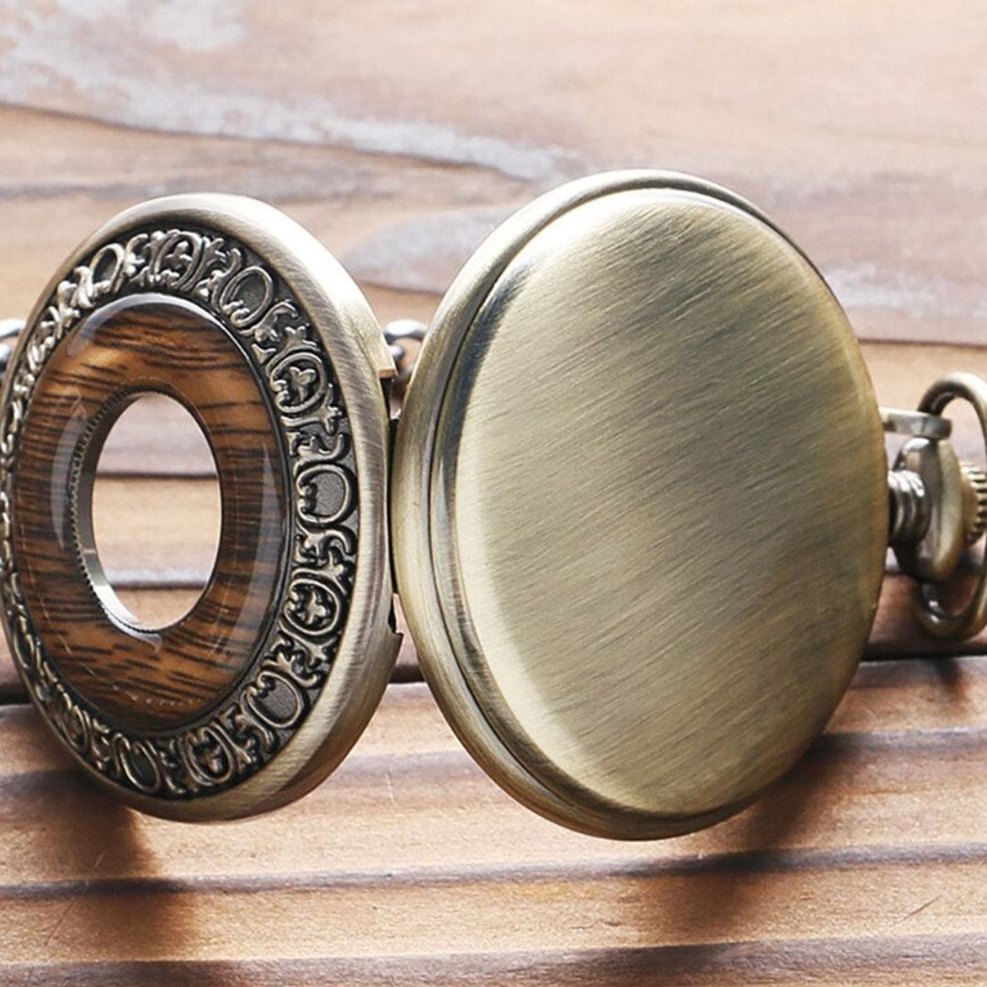 Open bronze pocket watch with wood and clear center.

