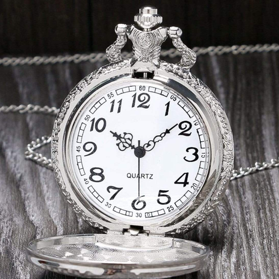 Silver pocket watch with white face and decorative bezel.