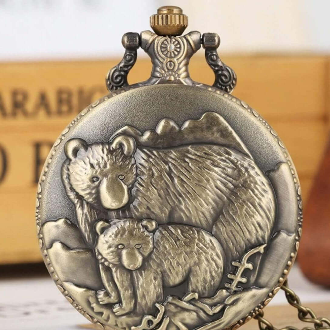 Bronze pocket watch with embossed bear and cub design.
