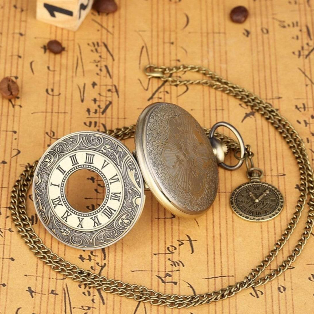 Opened antique pocket watch on chain, brown background with music notes and coffee beans.