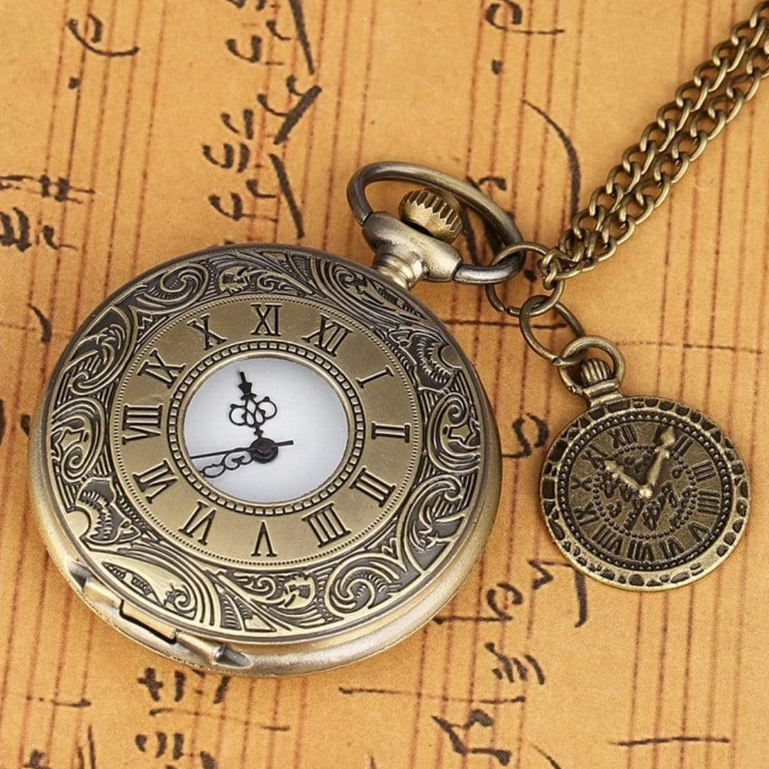 Vintage pocket watch with fob on script background.