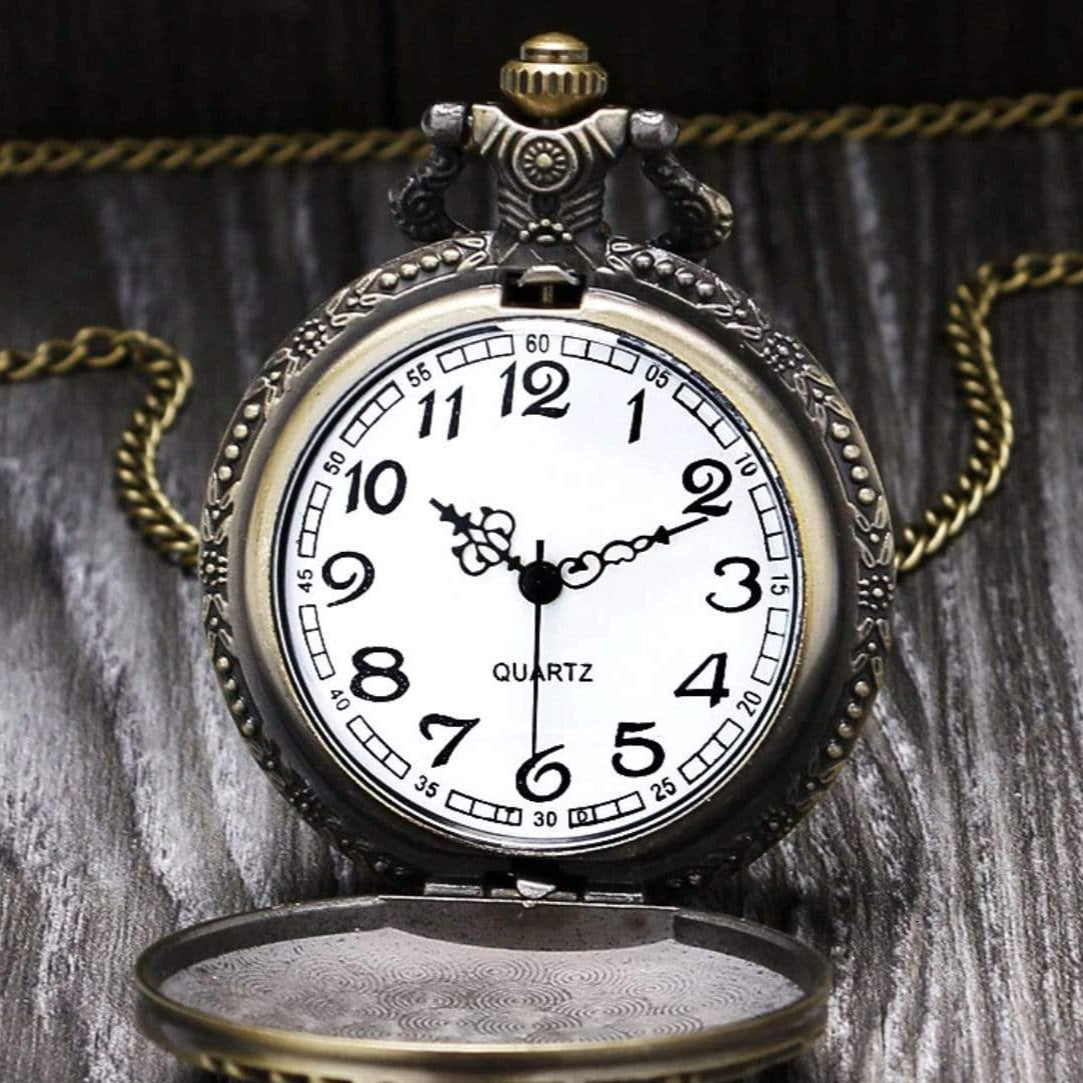 Opened antique bronze pocket watch with a chain.
