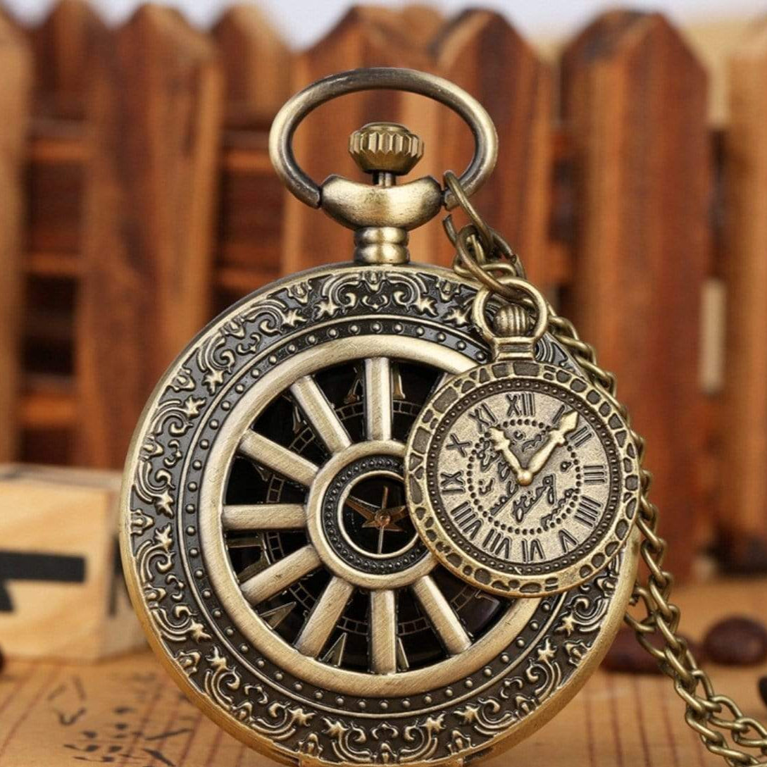 Close-up of a vintage-style bronze pocket watch with an ornate design and chain.