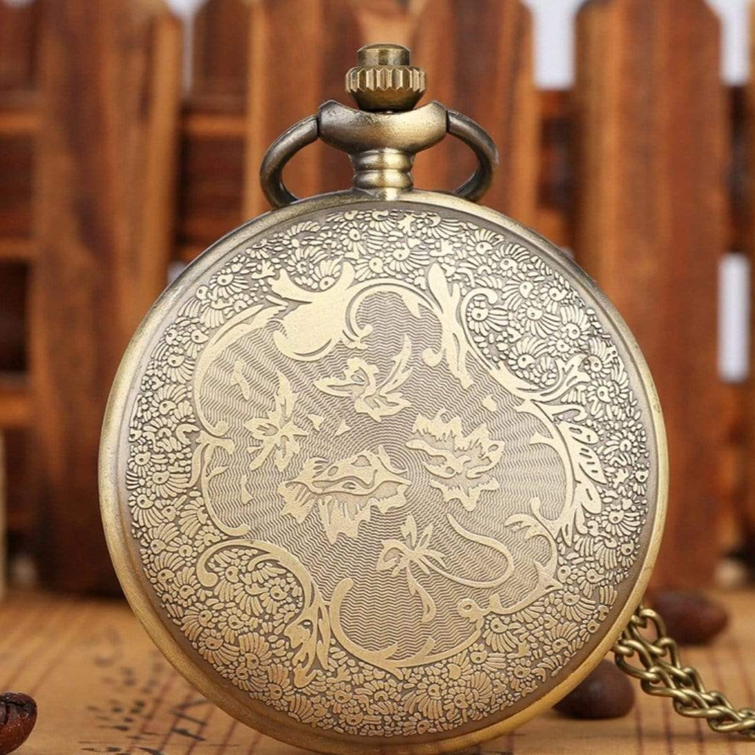 Close-up of a decorative bronze pocket watch.