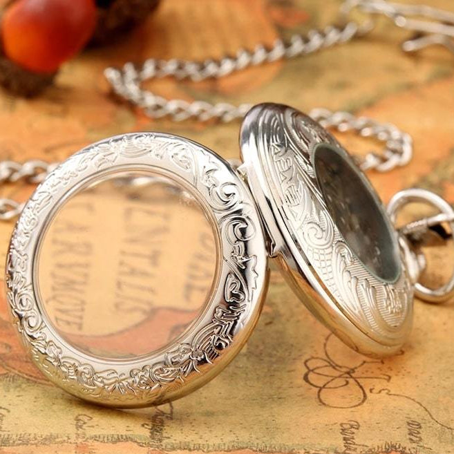 Silver ornate pocket watch.
