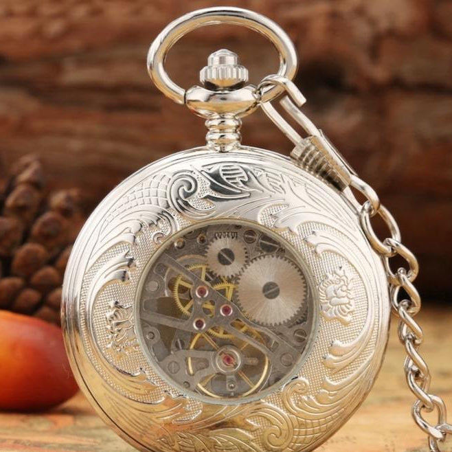 Silver pocket watch with exposed gears and chain.