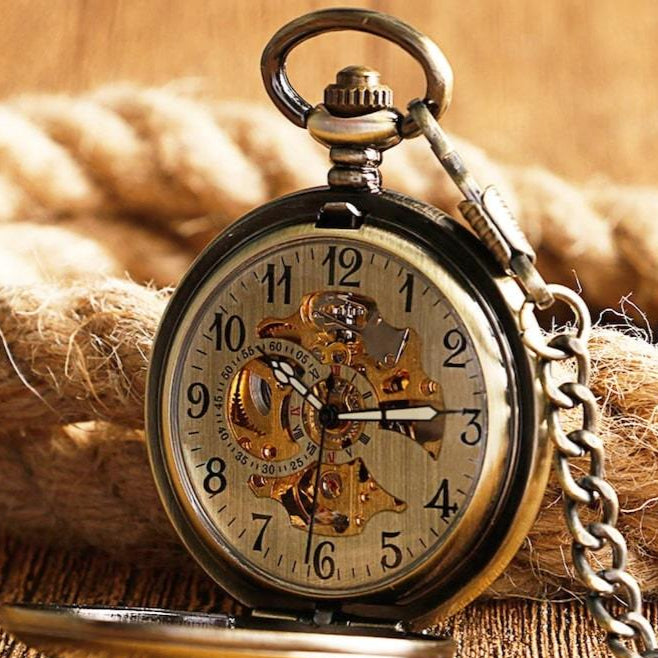 Vintage pocket watch with exposed gears on rope.