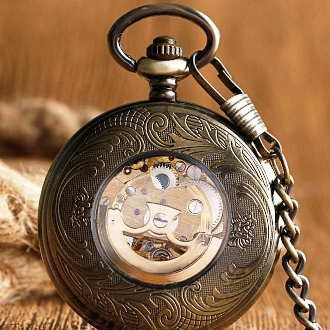 Gold pocket watch with exposed gears and chain.
