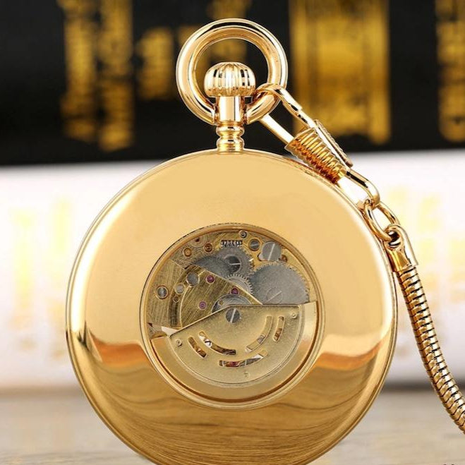 Gold mechanical pocket watch with exposed gears.
