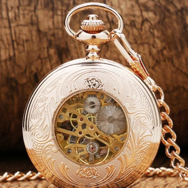 Rose gold pocket watch with exposed gears. 

