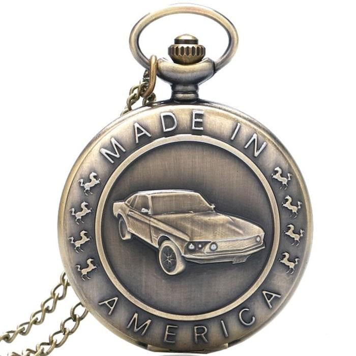 Brass pocket watch with "Made in America" inscription and a Mustang car depiction.
