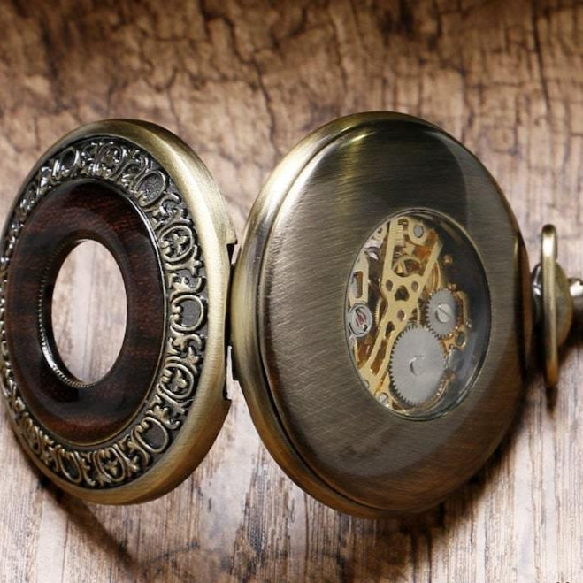 Open antique pocket watch with visible gears.
