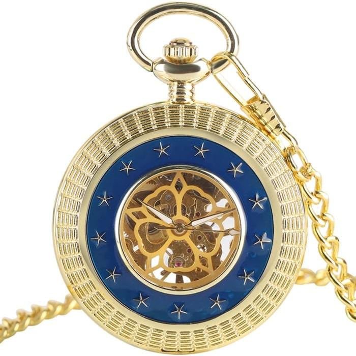 Gold-tone pocket watch with blue and star accents, chain.
