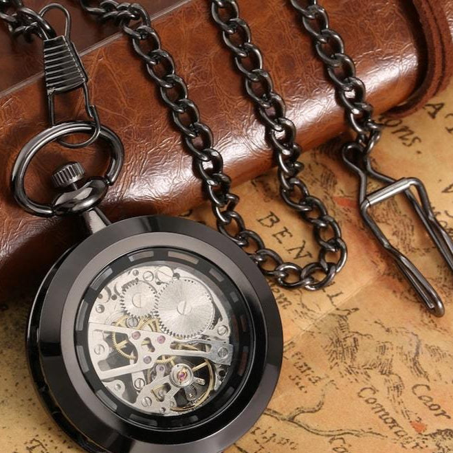 Black skeleton pocket watch with chain.
