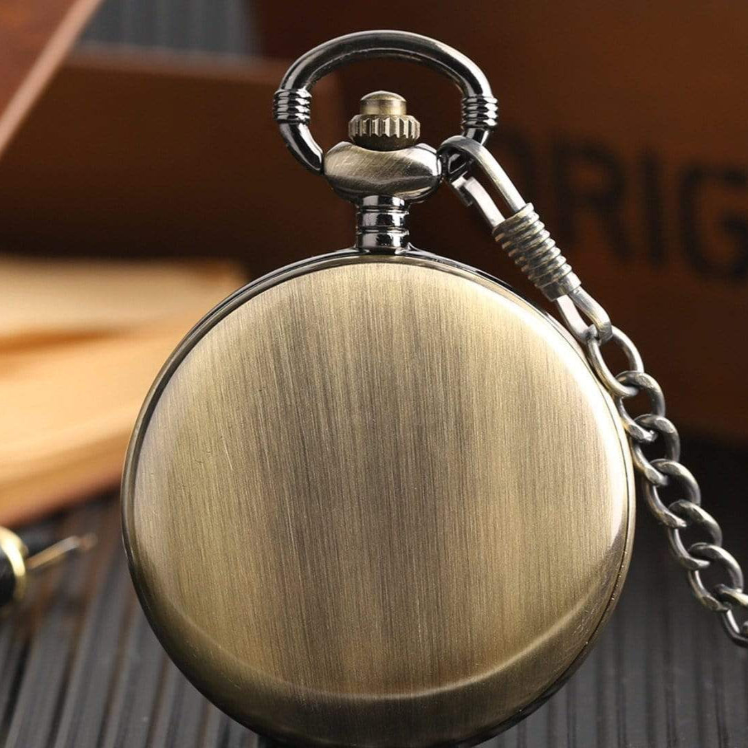 Closed bronze pocket watch with chain.