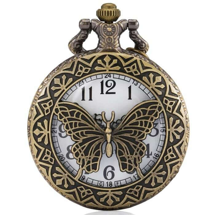 Antique-style pocket watch with a butterfly design.
