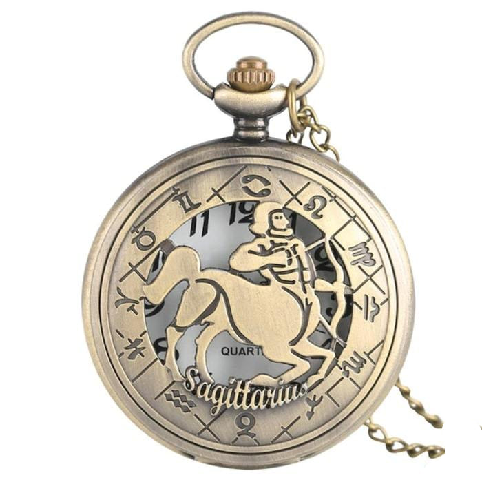 Close-up of an antique bronze pocket watch with a Sagittarius design.
