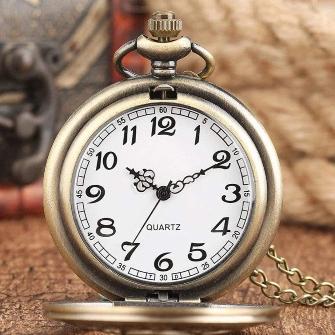 Vintage bronze pocket watch with white face and black numerals.
