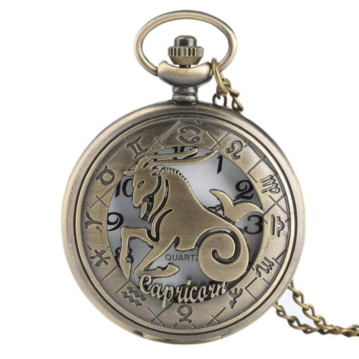 Bronze-tone pocket watch with Capricorn zodiac sign and chain.