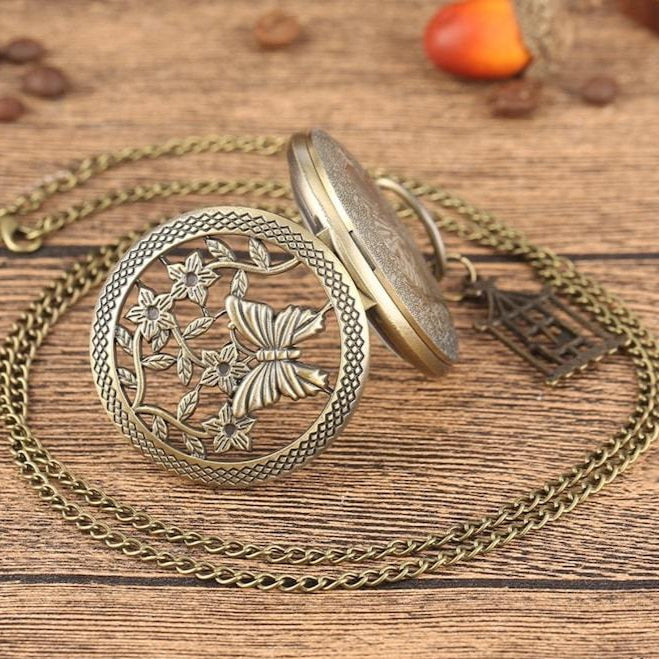 Close-up of a bronze necklace with a butterfly and floral motif.