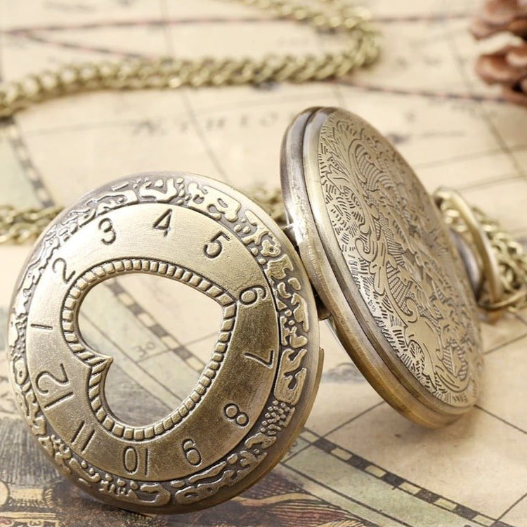 Vintage bronze pocket watch with open face, chain, and engraved design on a map background.
