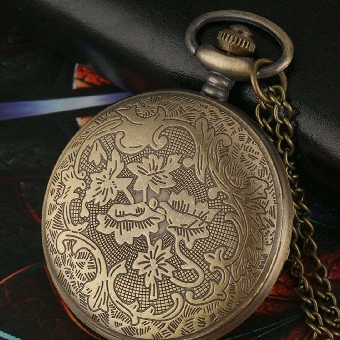 Embossed brass pocket watch with chain.
