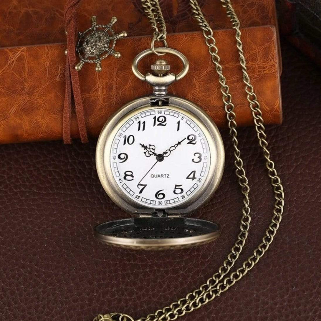 Close-up of an antique-looking pocket watch with a chain.