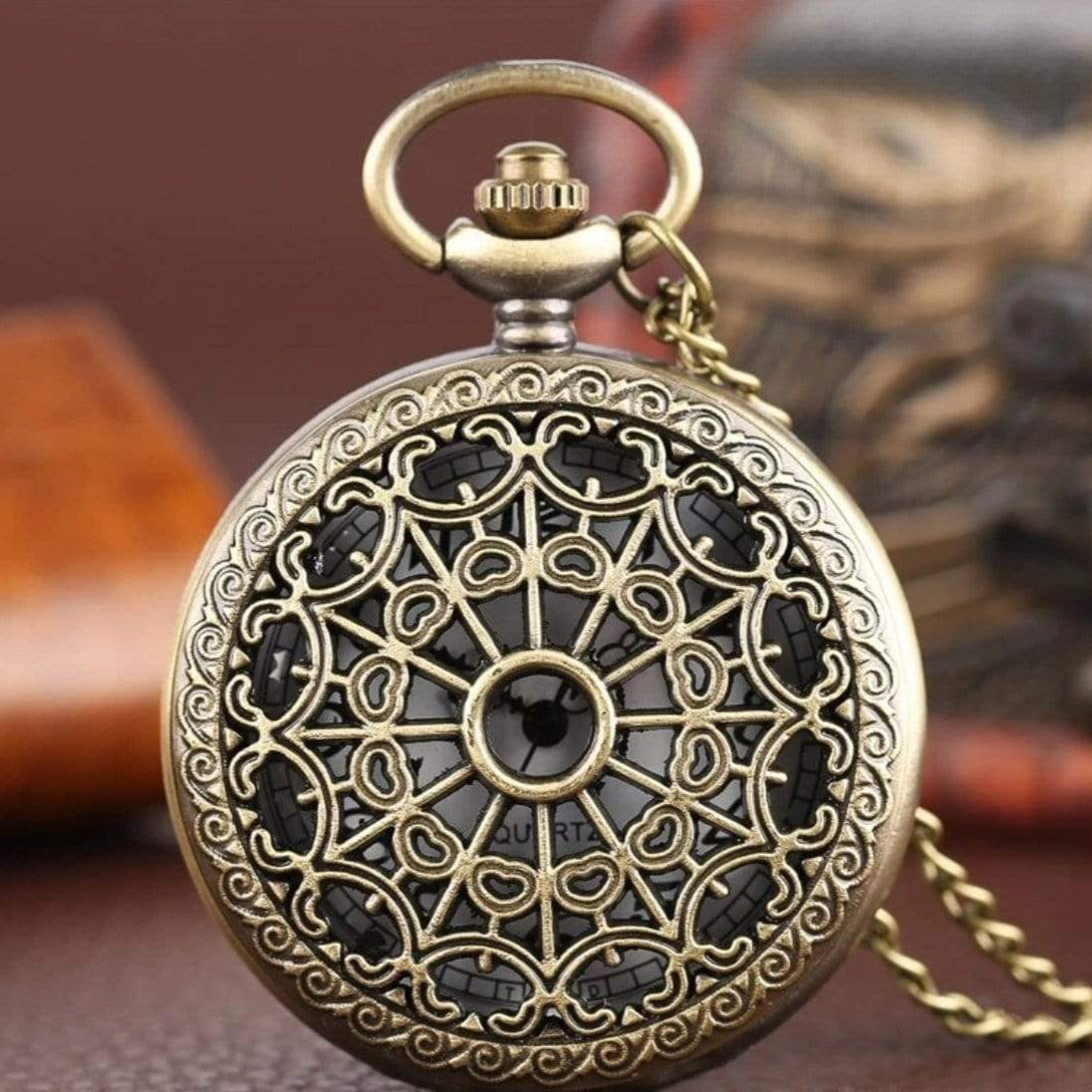 Ornate, golden, filigree-covered pocket watch. 
