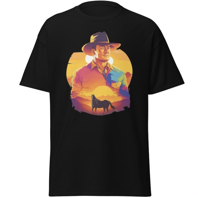 Black t-shirt featuring a graphic of a cowboy wearing a hat standing in front of a sunset with a horse.