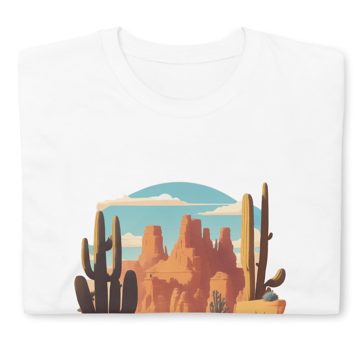 Folded white t-shirt with a desert landscape graphic.
