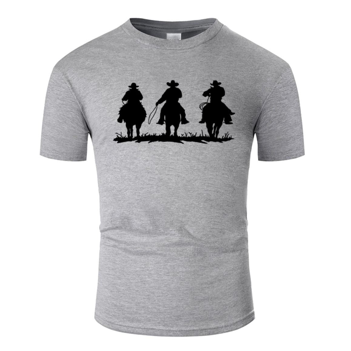Grey t-shirt with black silhouette of three cowboys on horseback.
