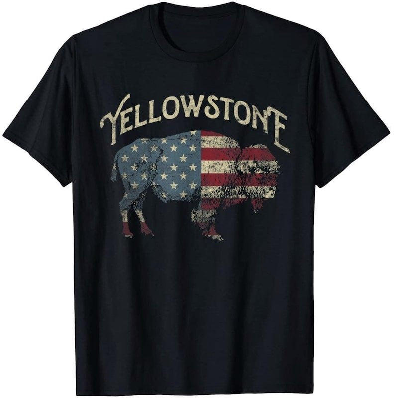 Black t-shirt with a vintage-style graphic of a buffalo filled with the American flag and "Yellowstone" printed above.